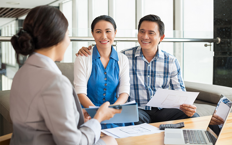 Couple smiling while with a property agent