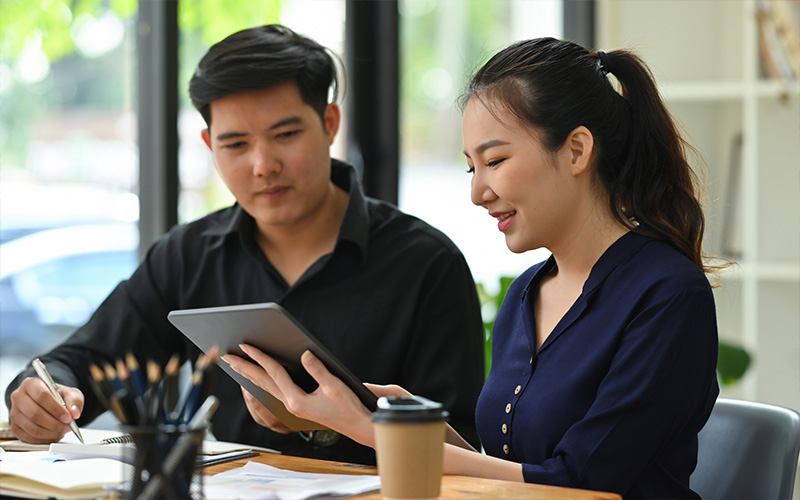 Image of 2 people collaborating on an iPad