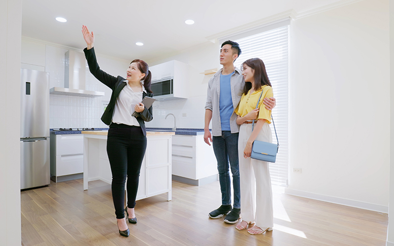 Real estate broker showing a house to a couple of prospective buyers