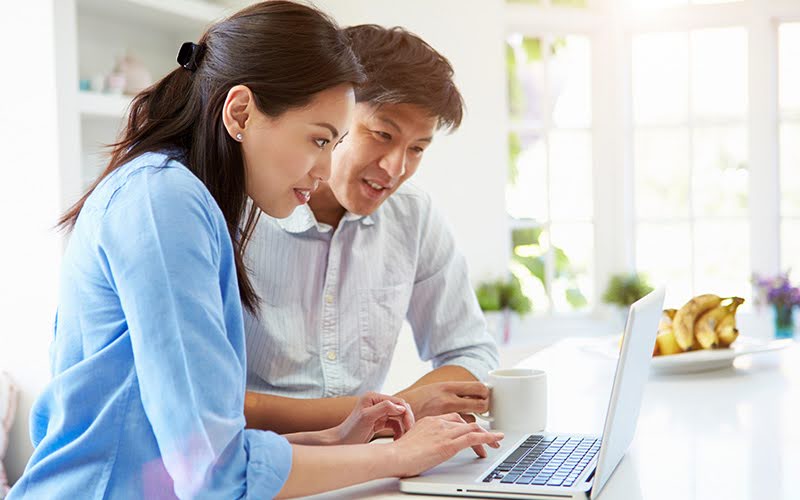 A Couple reading a contract on their laptop