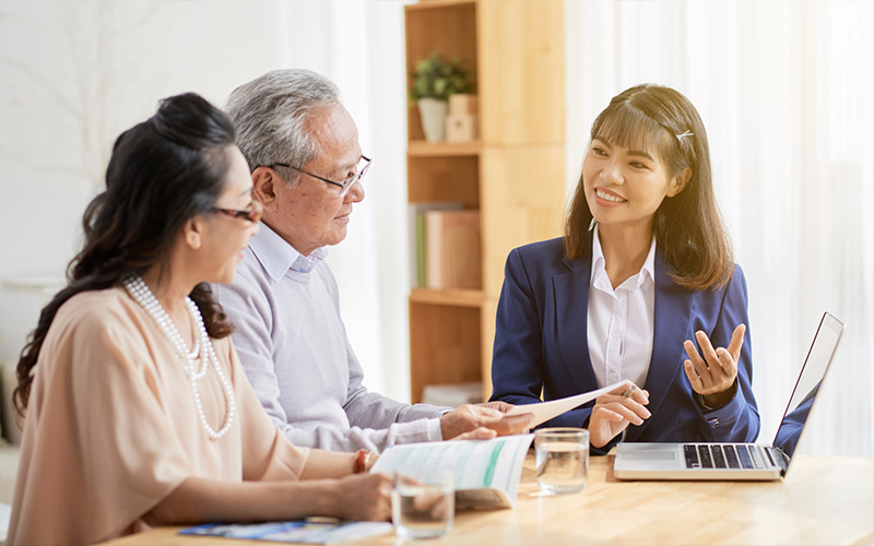 Senior asian couple listen to explanation by a property valuer