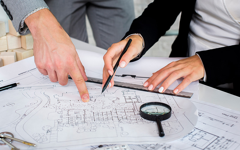 Architects reviewing residential building blueprints.