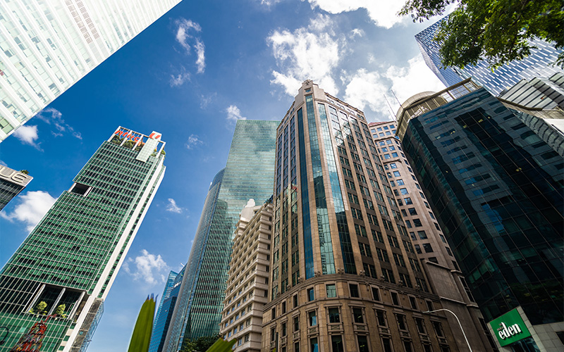 Tall city buildings representing investment properties.