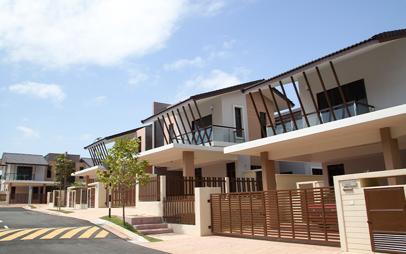Row of modern suburban houses under blue sky.