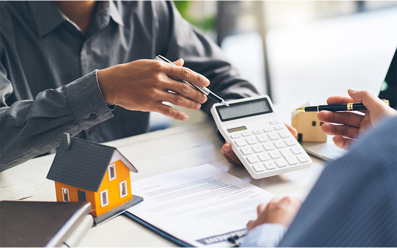 CKS home valuer calculating property appraisal with a calculator.