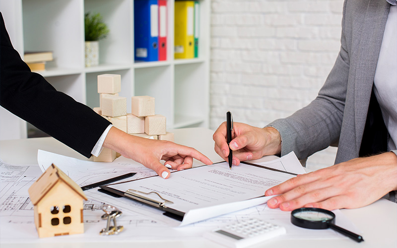 Property valuer discussing documents with a client.